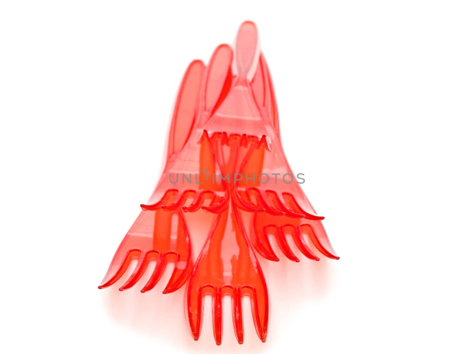 Photo of the red plastic forks against the white background