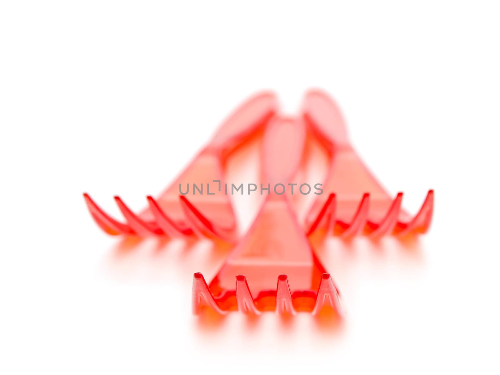 Photo of the red plastic forks against the white background