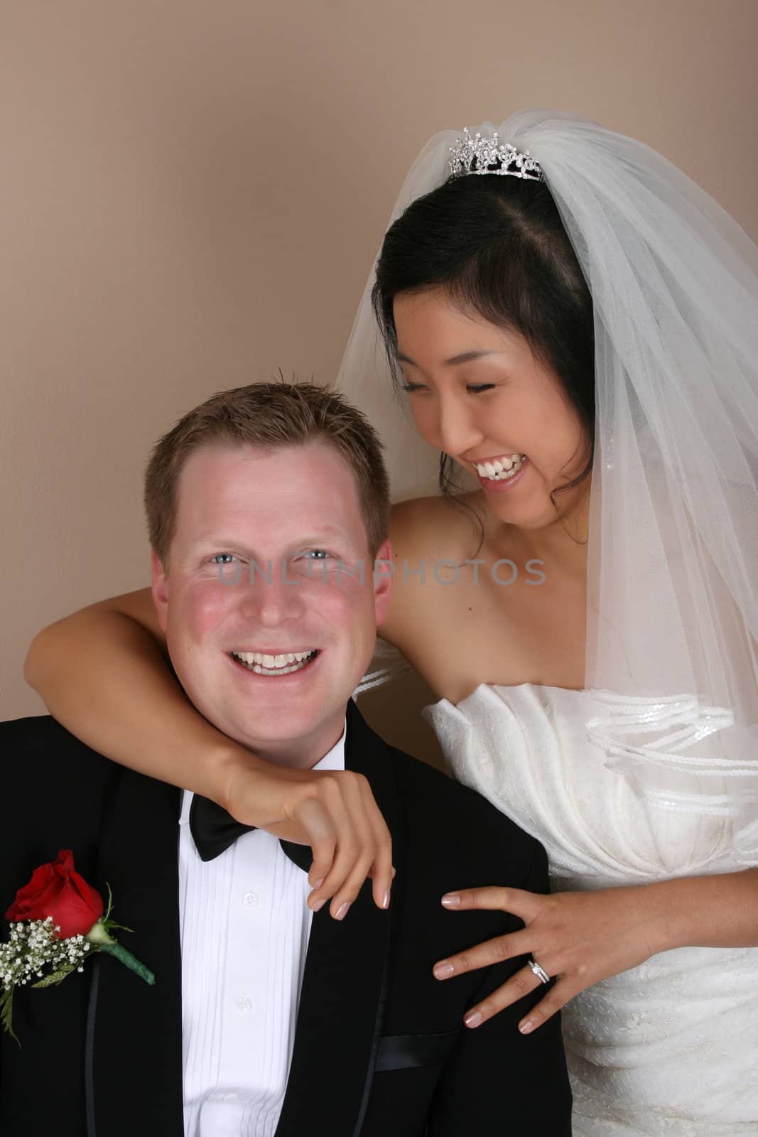 Beautiful Asian and Causian bridal couple on their wedding day