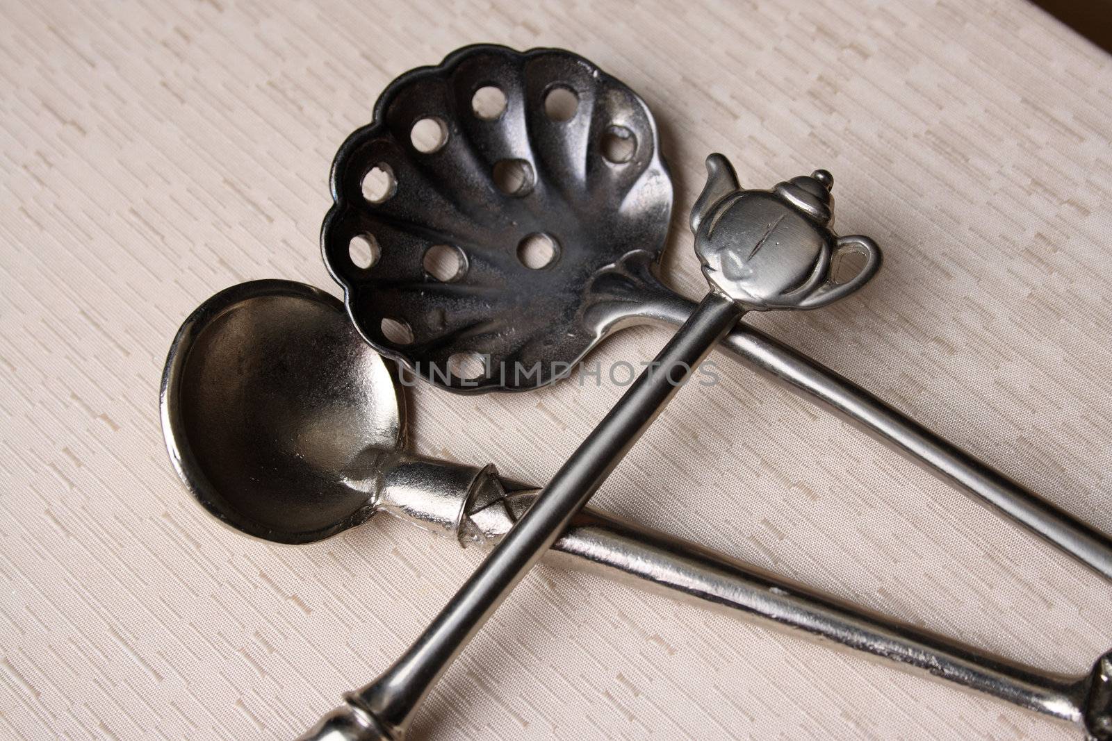 Silver spoons on a cream coloured box background