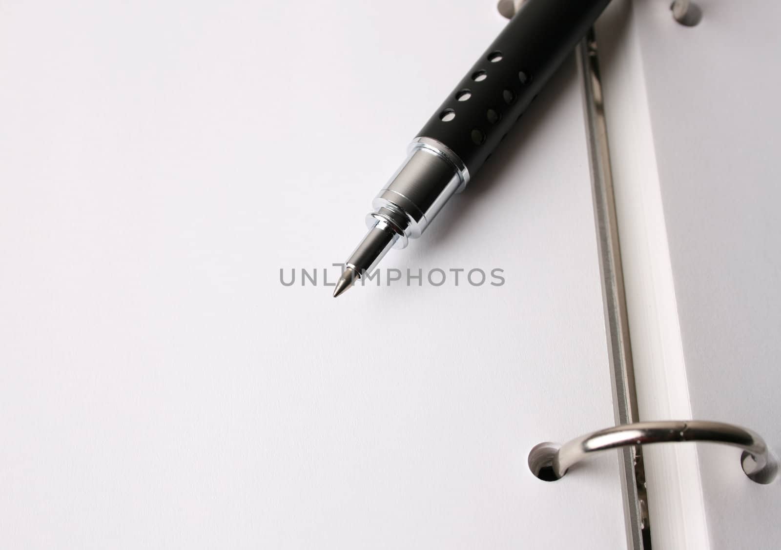 Fancy pen on a small file with white pages