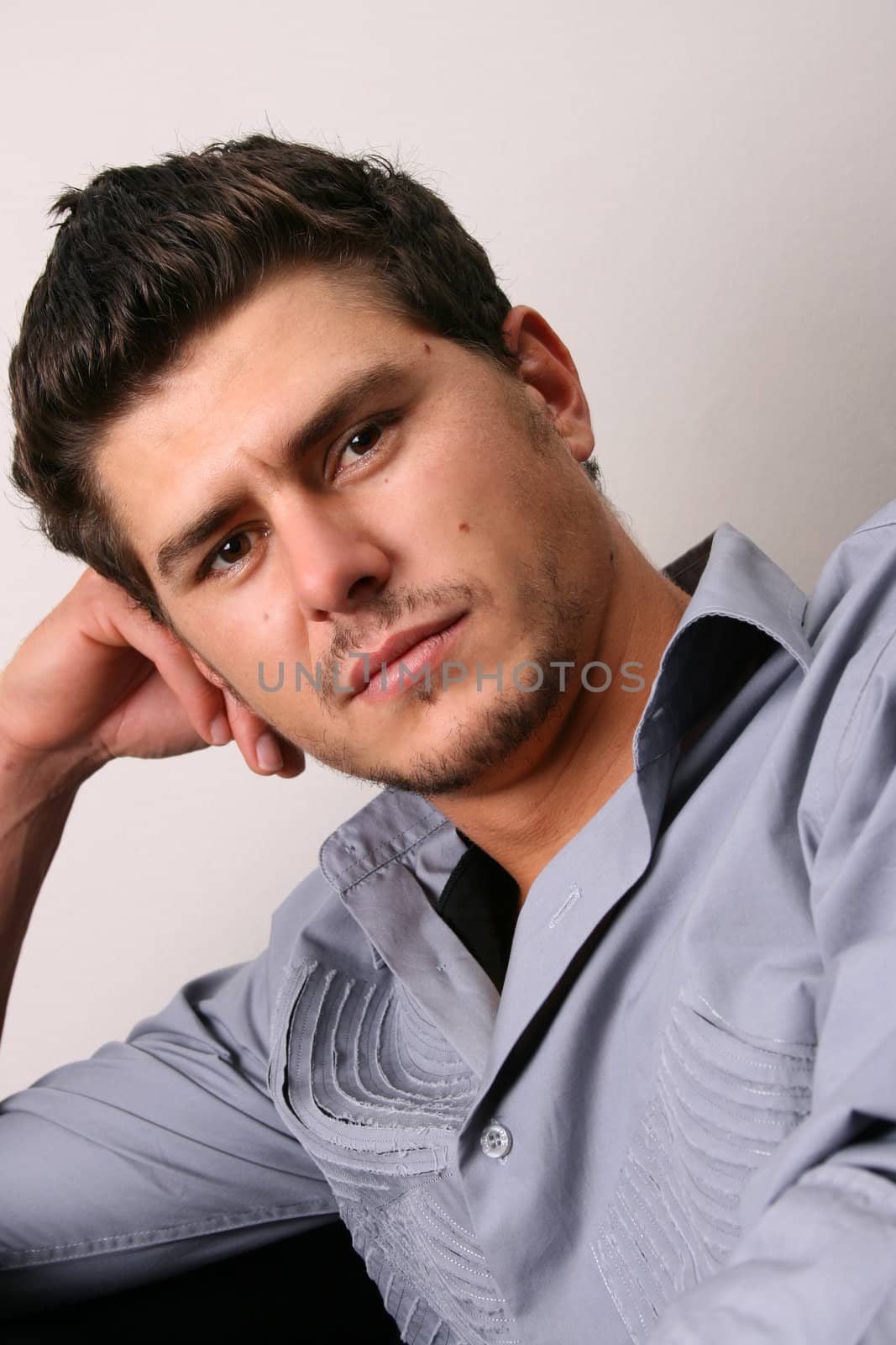 Male model in studio against white wall