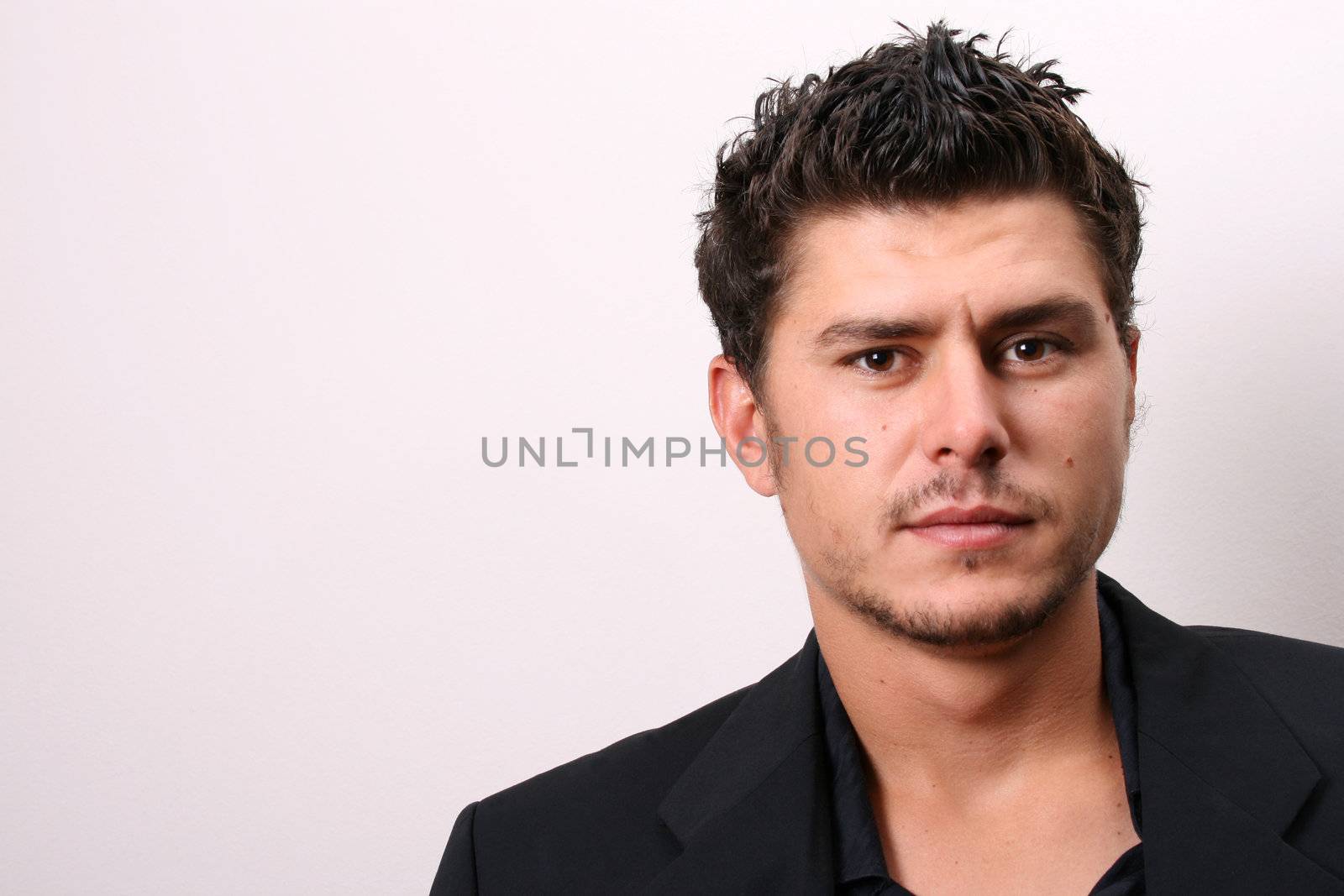 Male model in studio against white wall