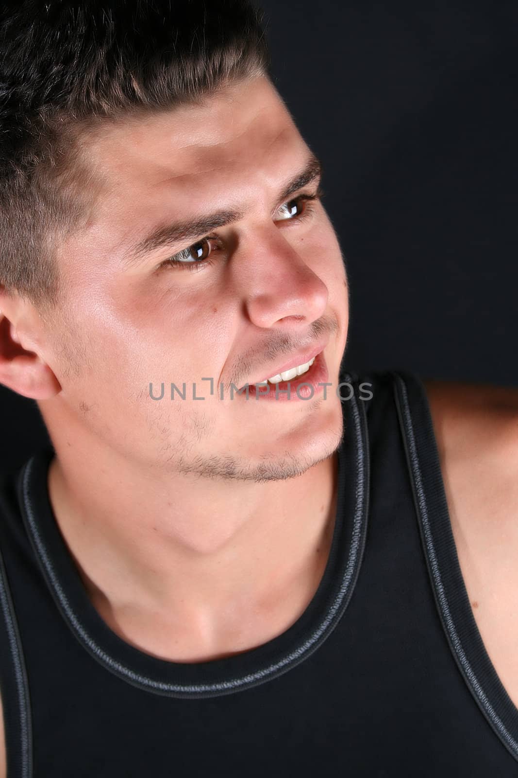 Male model in studio against a dark wall