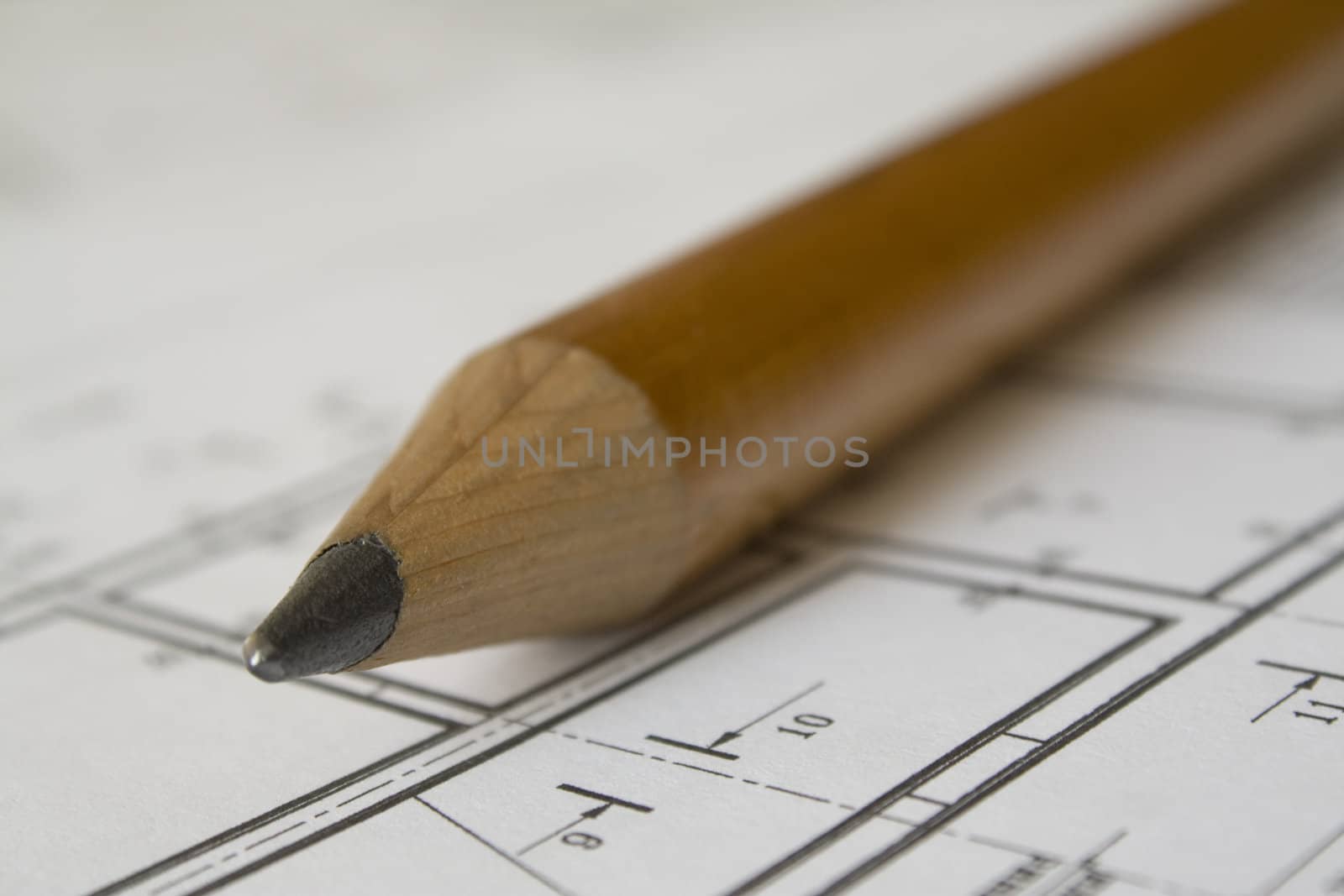 Big pencil on drawing printed on white paper