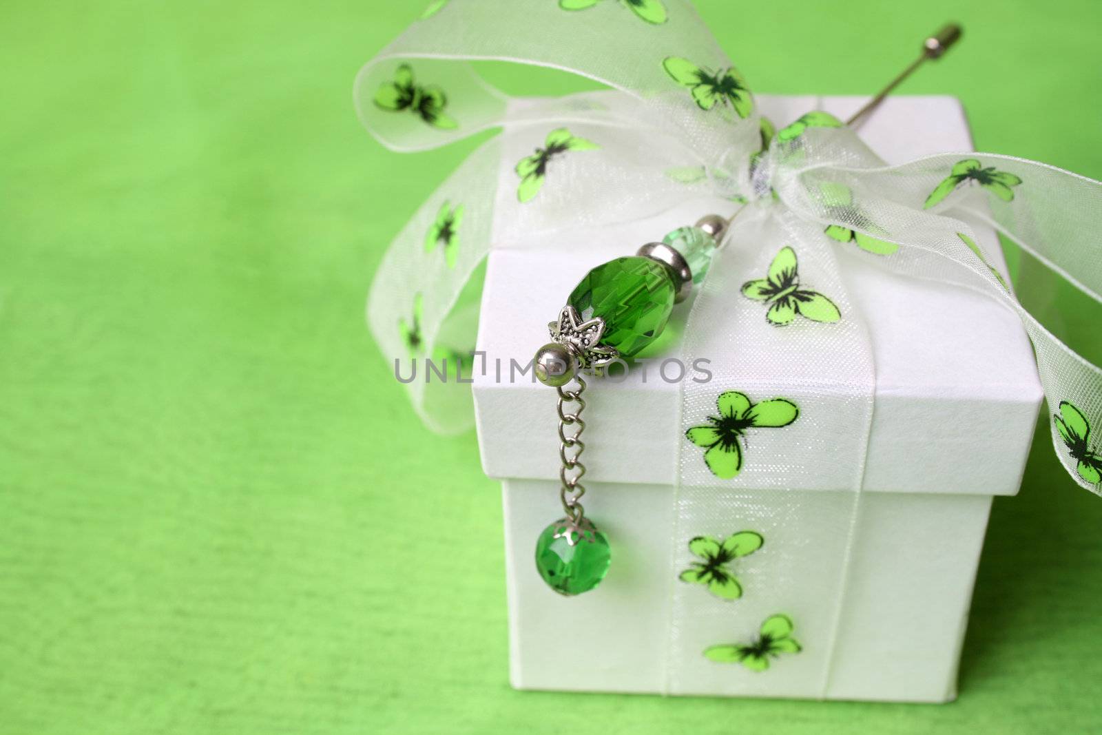 White gift box with butterfly ribbon and pin