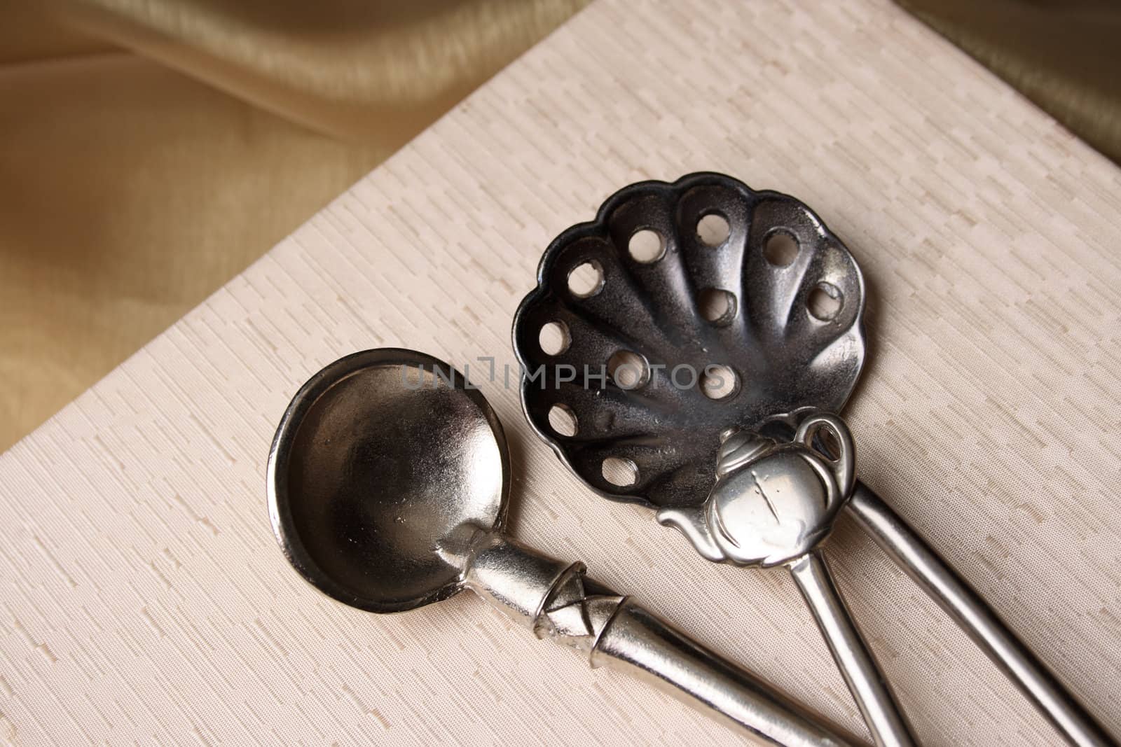 Silver spoons on a cream coloured box background