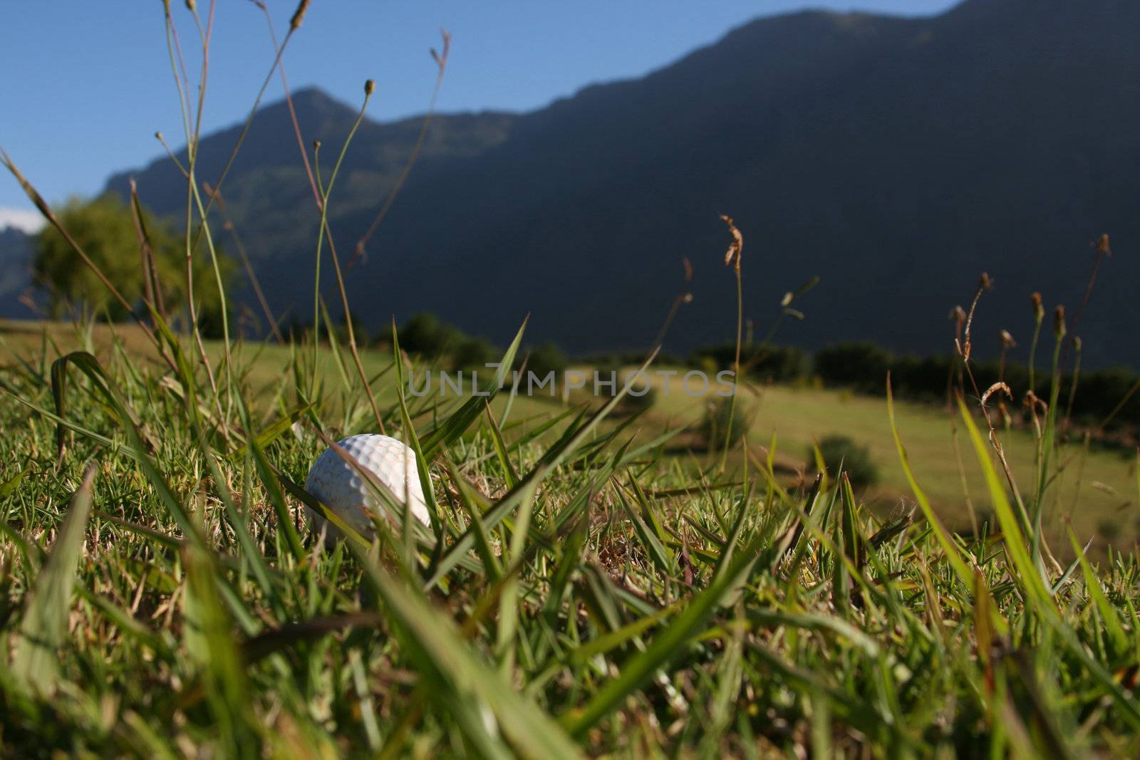 Golf Ball on a golf course with a mountain range in the background
