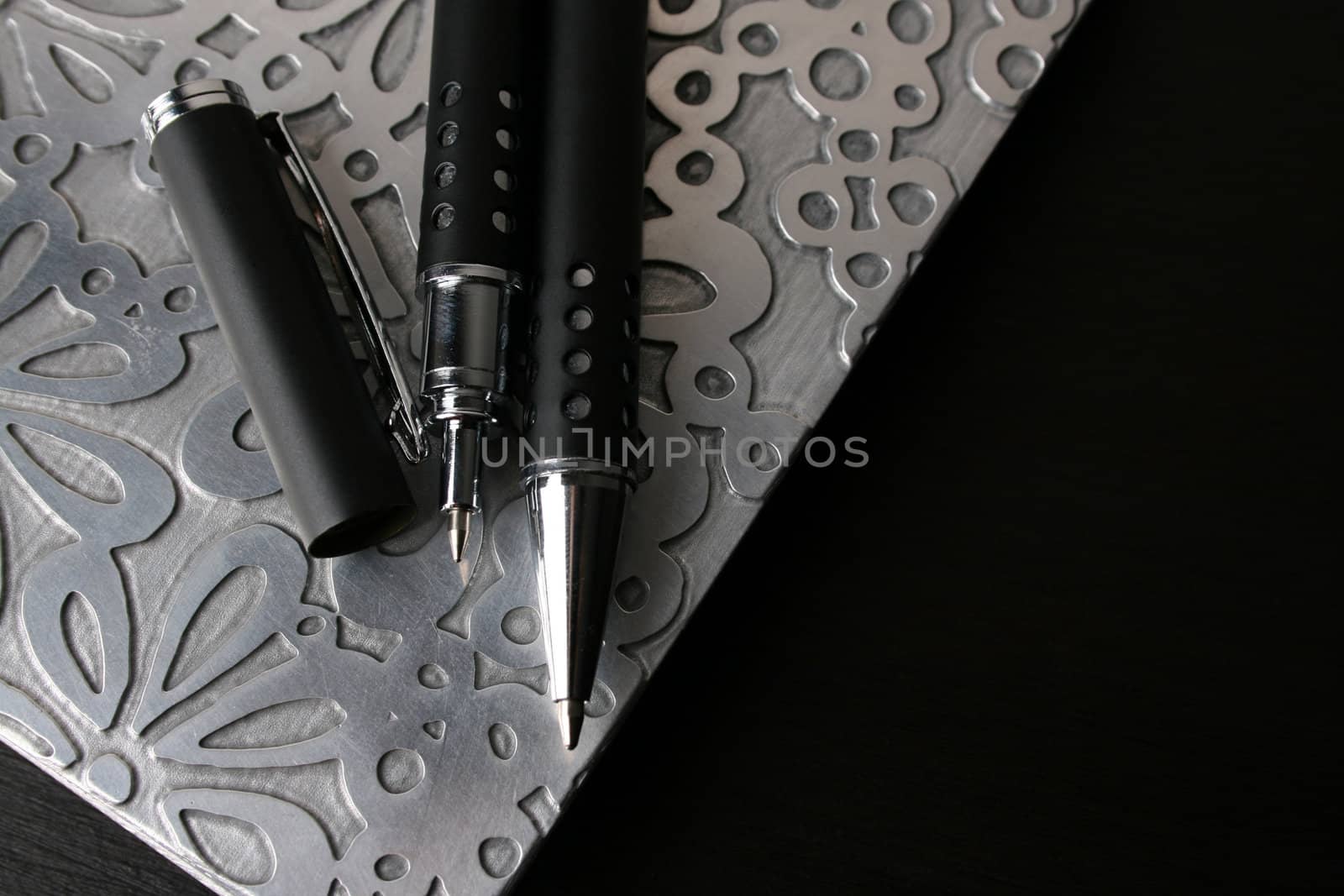 Fancy pen on a small file with white pages