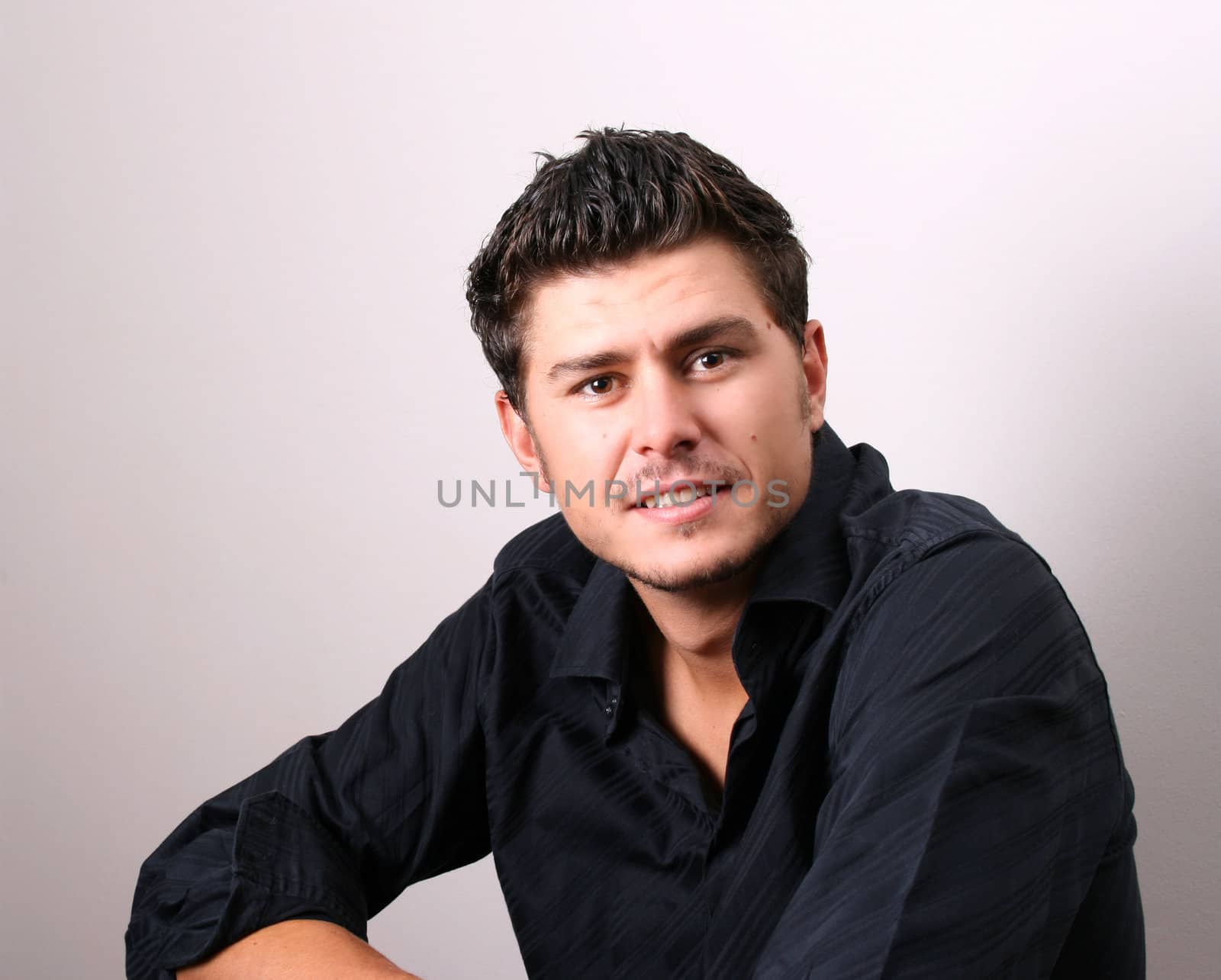 Male model in studio against white wall