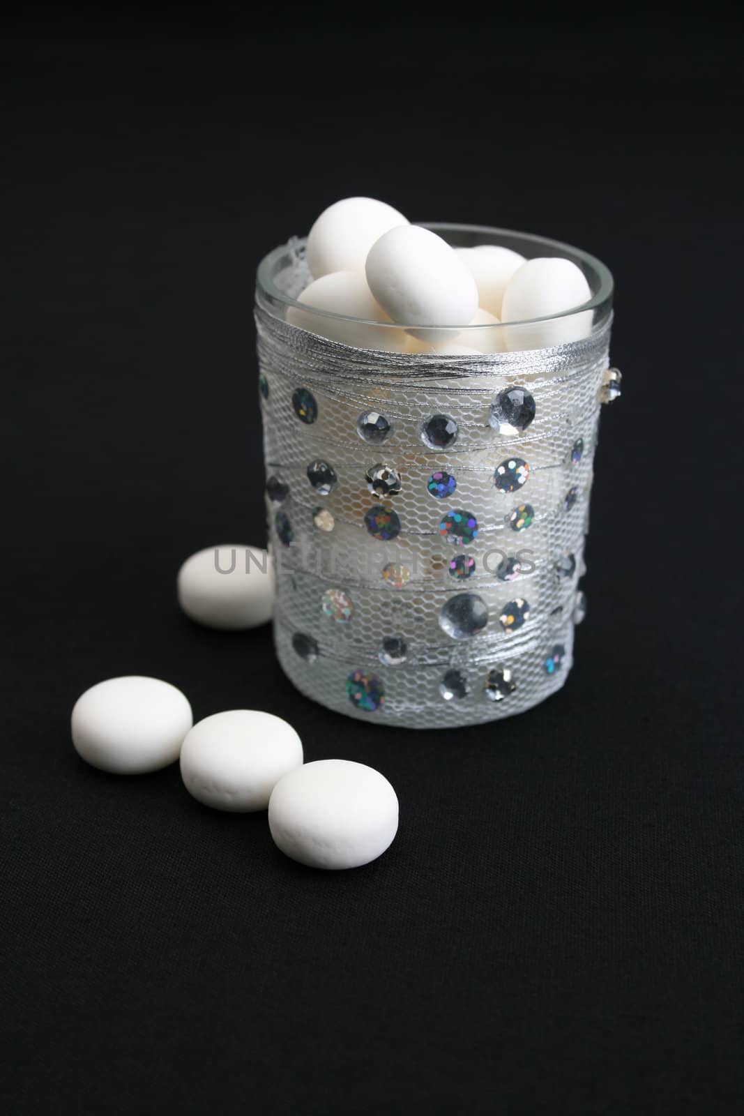 Decorated glass wih mints on a black background