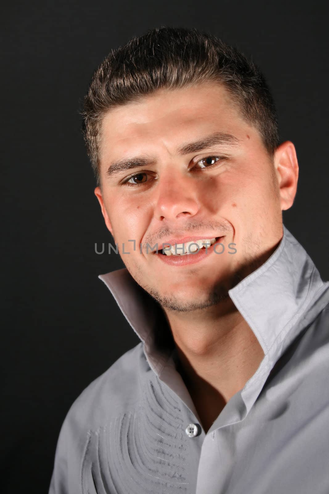 Male model in studio against black background