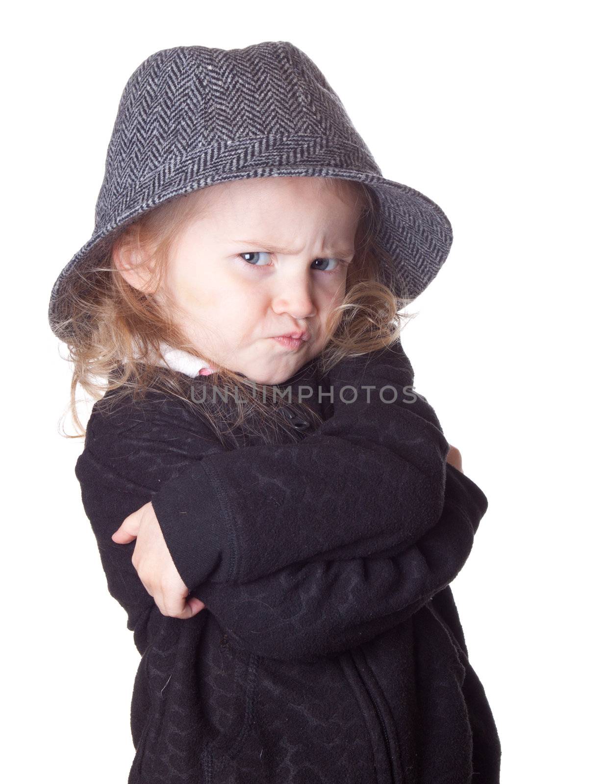 An isolation on white of an adorable child.  Her arms are crossed.