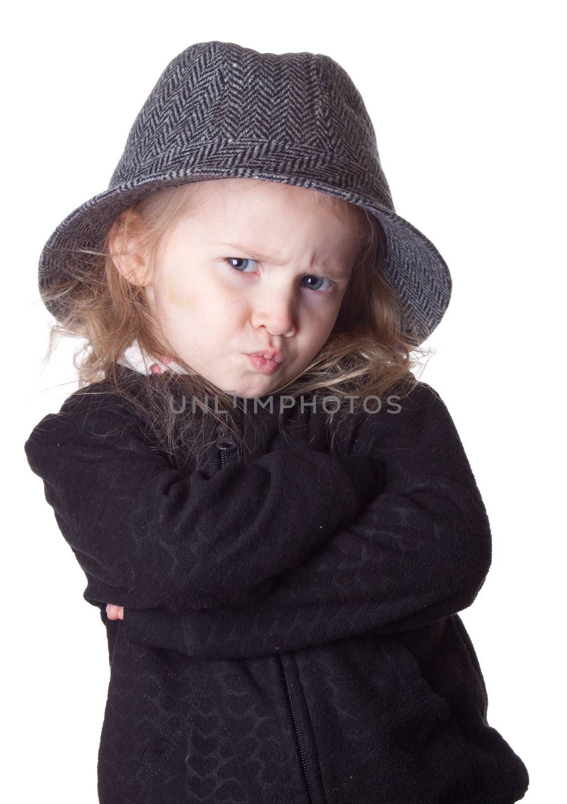 An isolation of a child on white.  Her lips are pursed and she is very serious.  Way too cool.