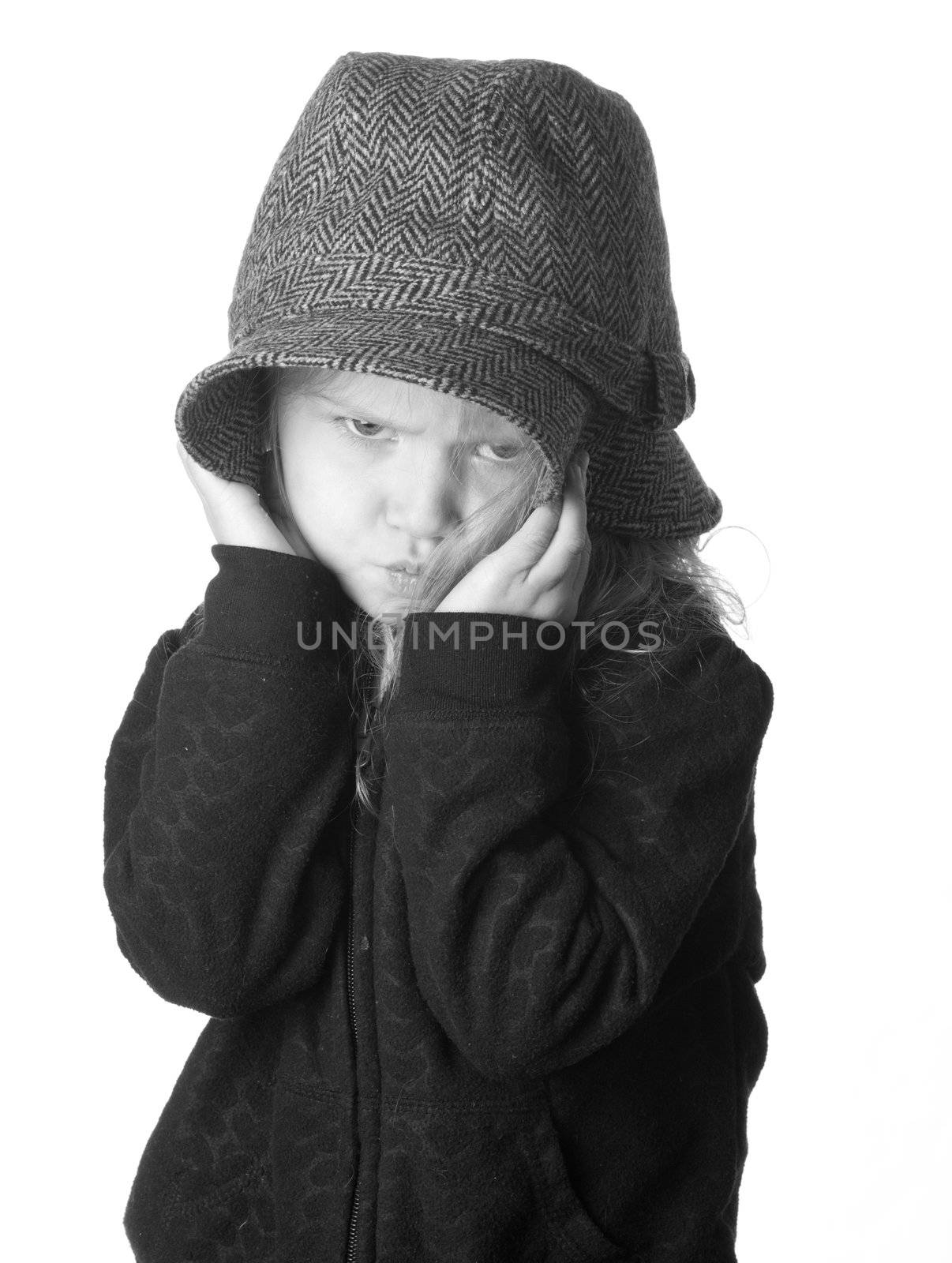 A black and white isolation of a girl that is hiding her face.