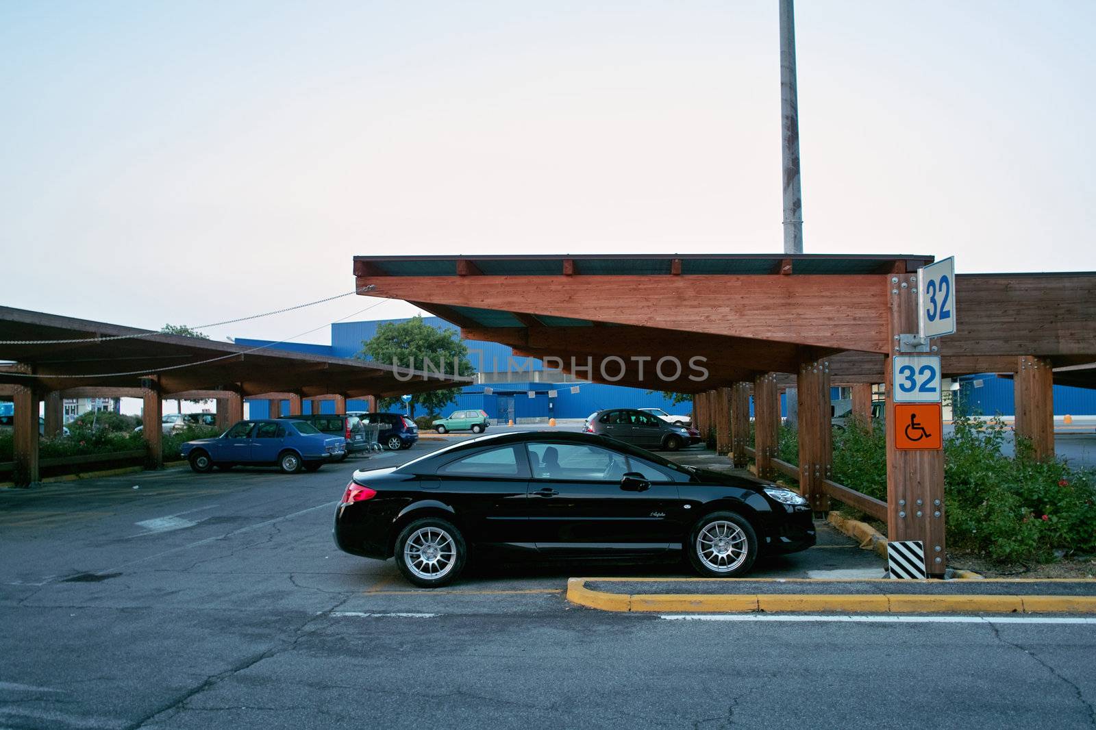 a sports car with no disable sign parked in a special place for disabled car