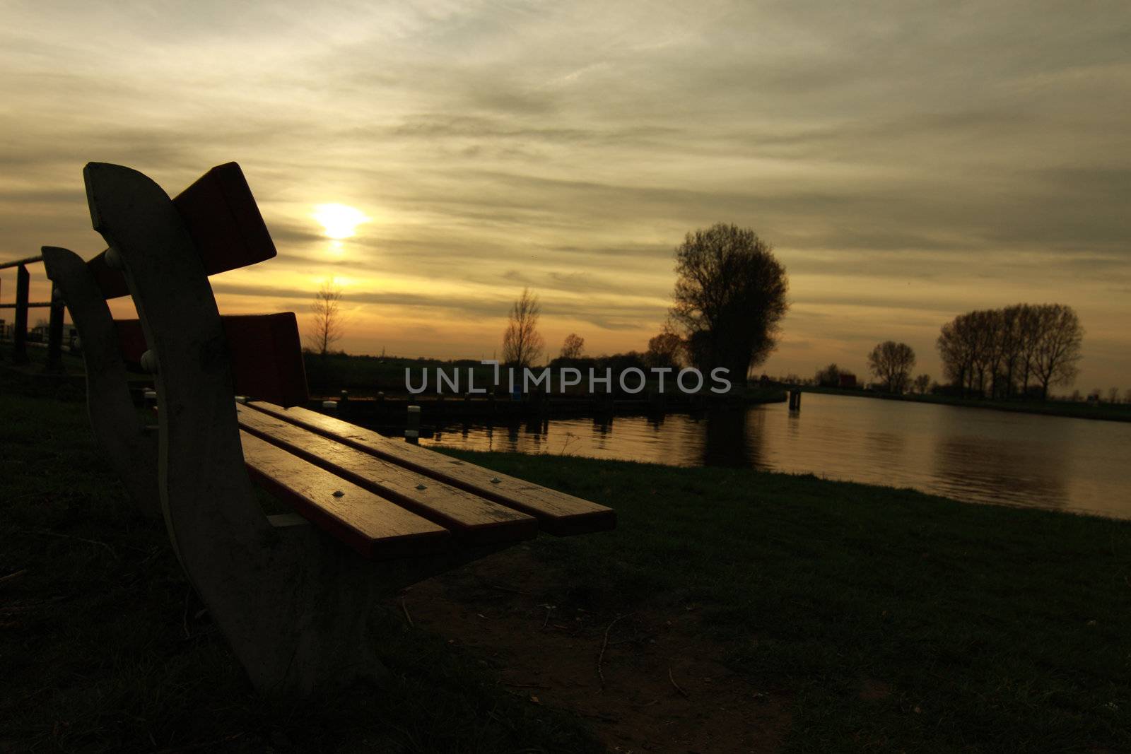 sunset with bench and water