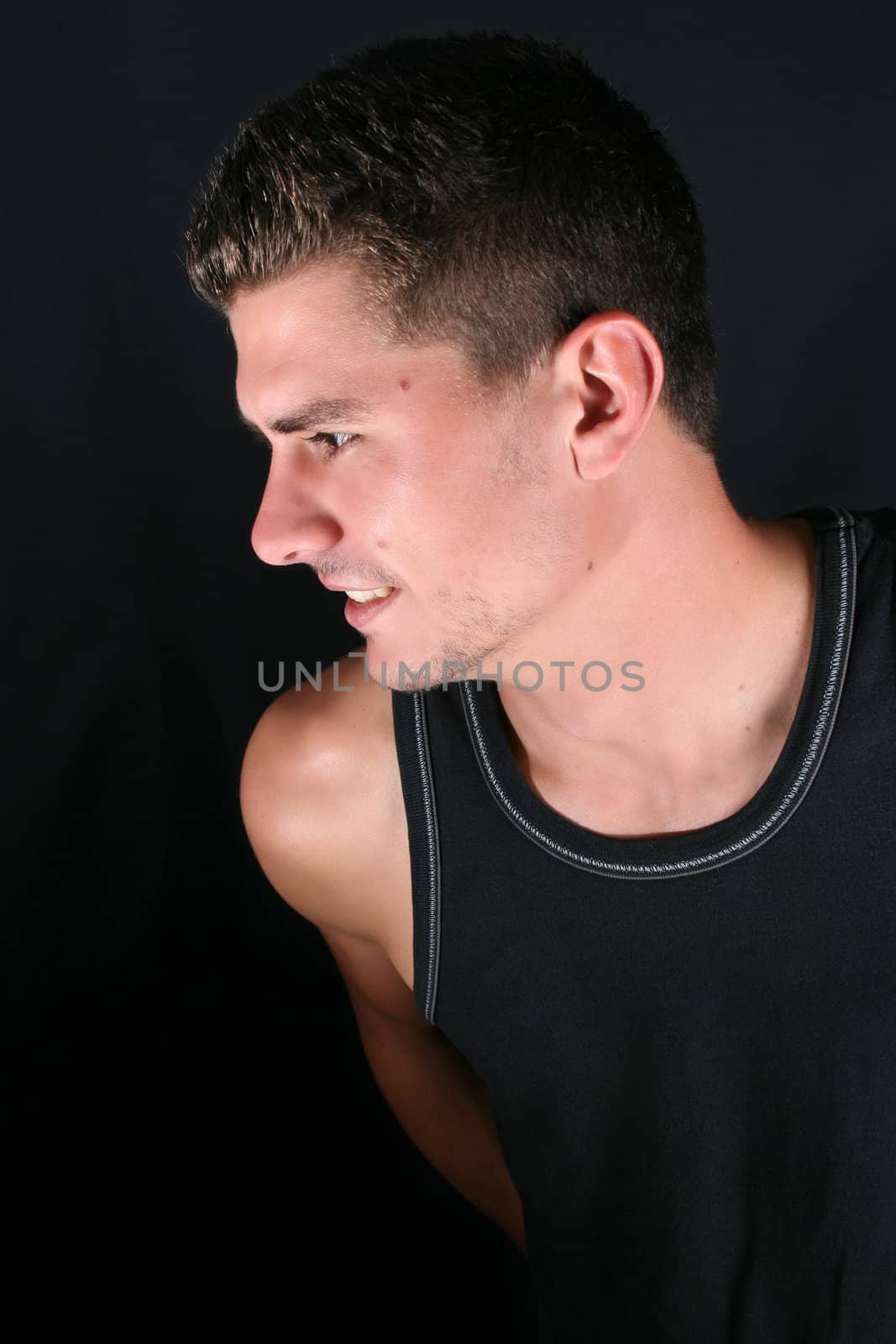 Male model in studio against black background