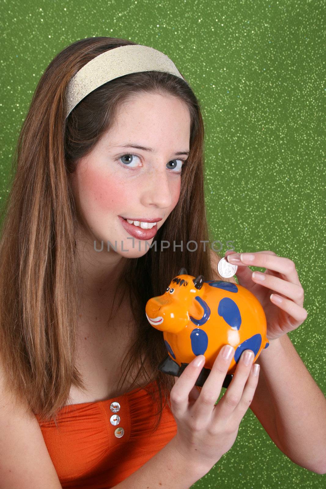 Brunette teenager on a green background wearing a broad head band