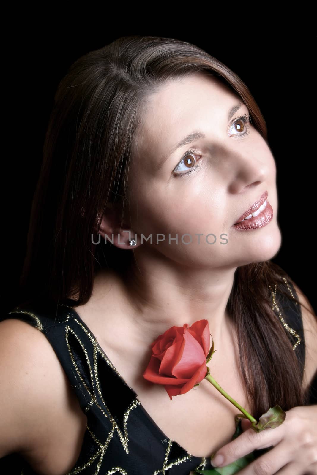 Brunette model holding a red rose, looking into the distance. Filtered Image.