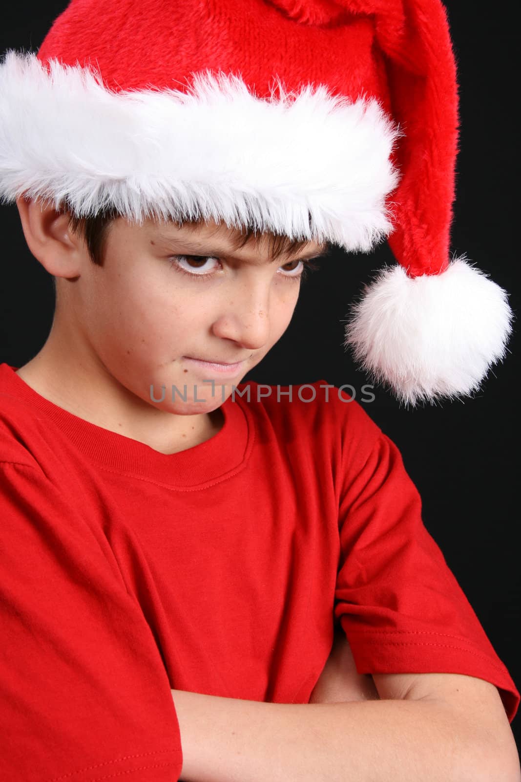 Young boy wearing a red shirt and christmas hat