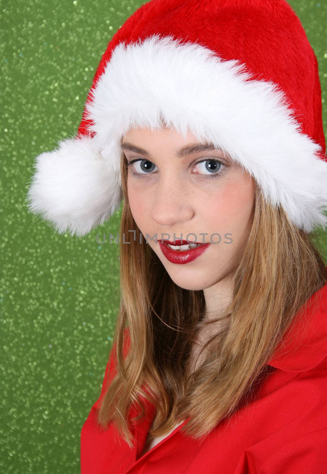 Teenager with red lips wearing a christmas hat