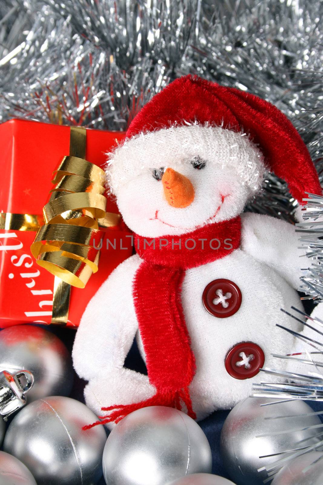 Wrapped christmas gifts with tinsel and snowman decoration