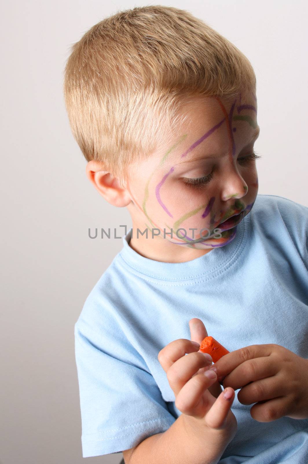 Laughing Toddler playing with colored pens making a mess