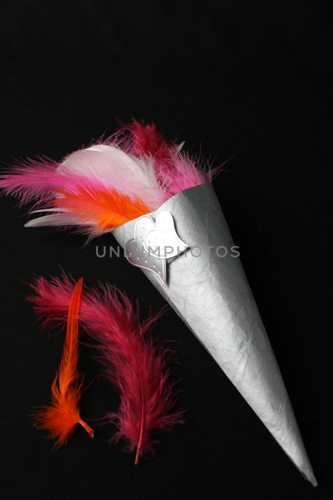 Brightly colored feather confetti in a cone