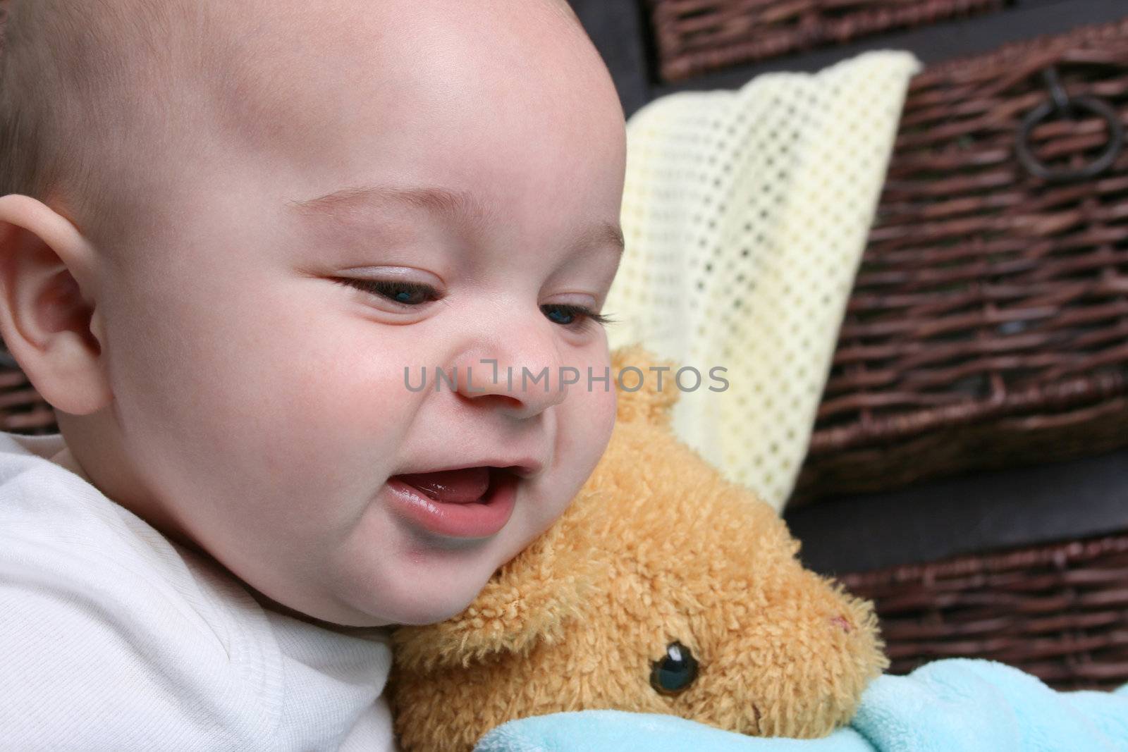 Six month old baby sitting infront of wooden drawers