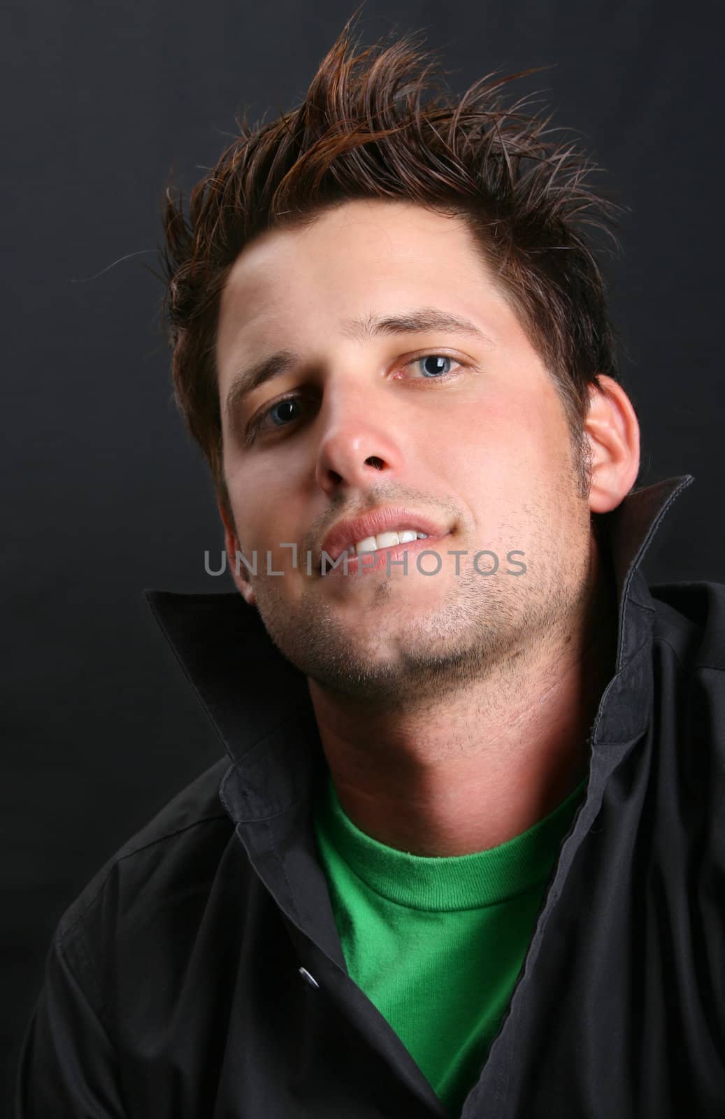 Male model in studio against black background