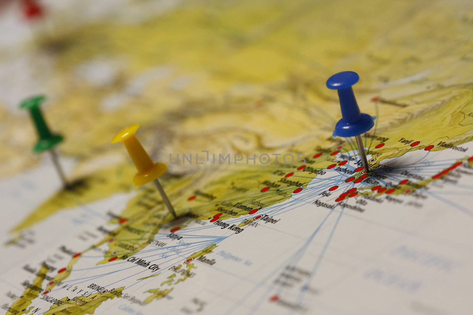 A push pin is inserted on a travel destination of a map.