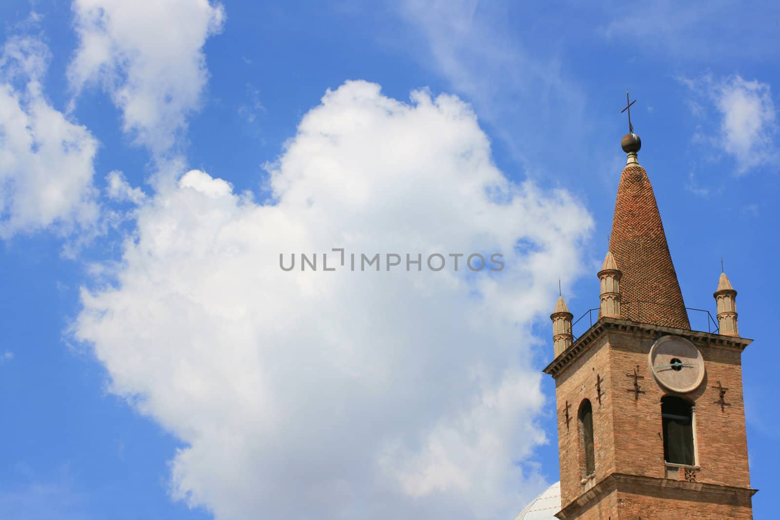 Piazza del popolo, Rome Italy. Church set against a blue sky with crisp white clouds.