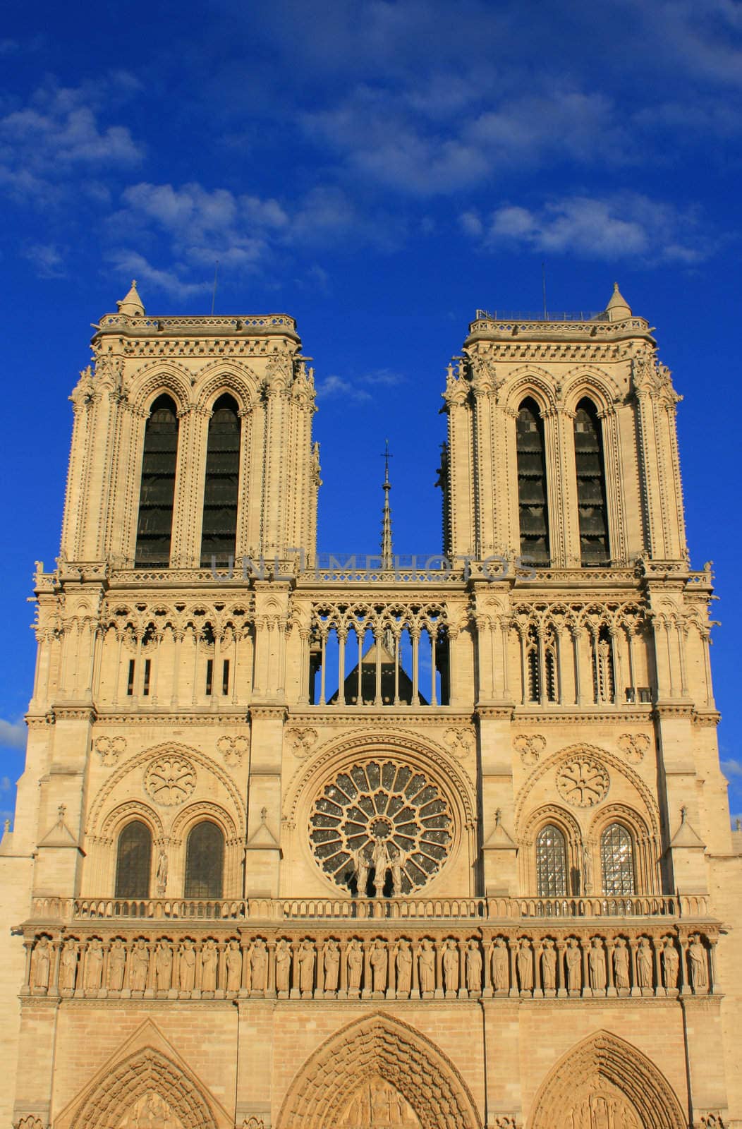 Notre Dame Cathedral, Paris France. Set on a deep blue sky at sunset.