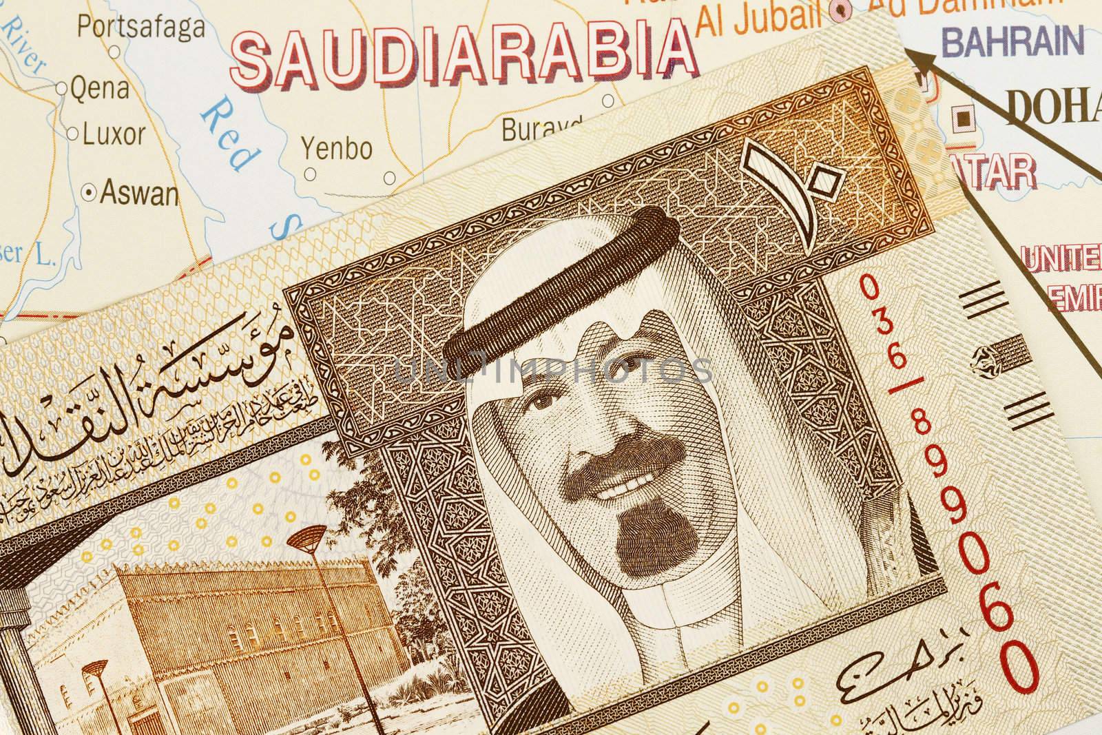 Close up shot of Saudi Arabia money and map.