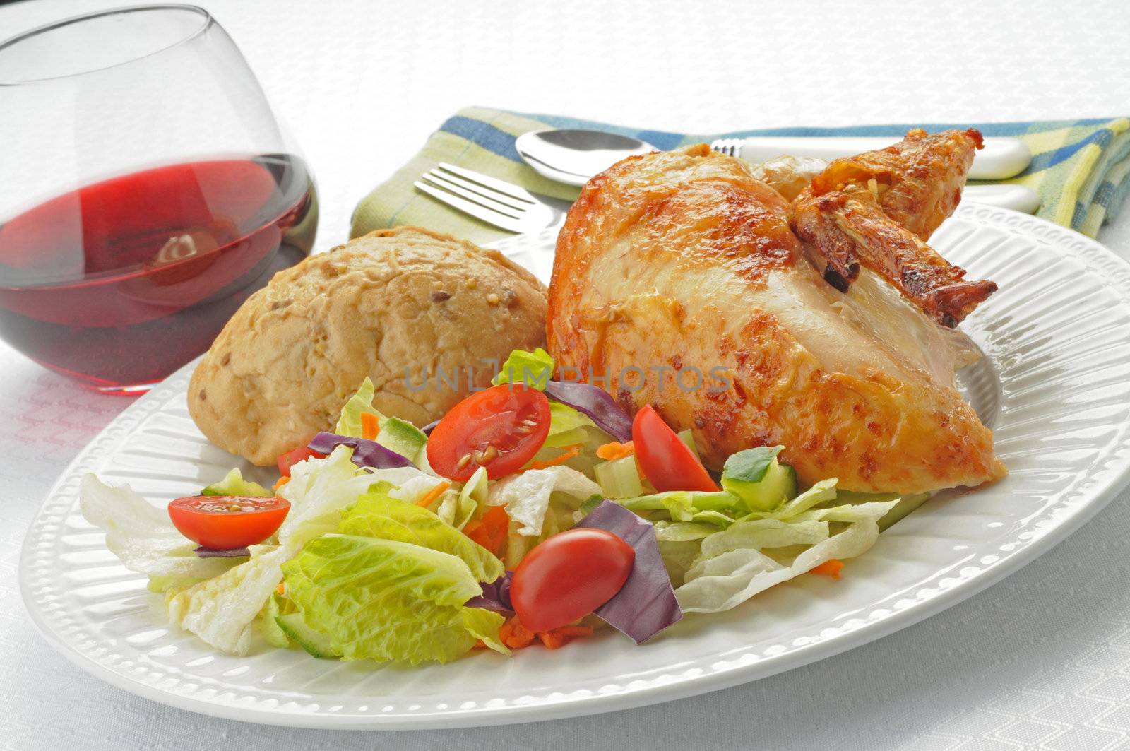 Tasty dinner of barbecued chicken and a side salad.