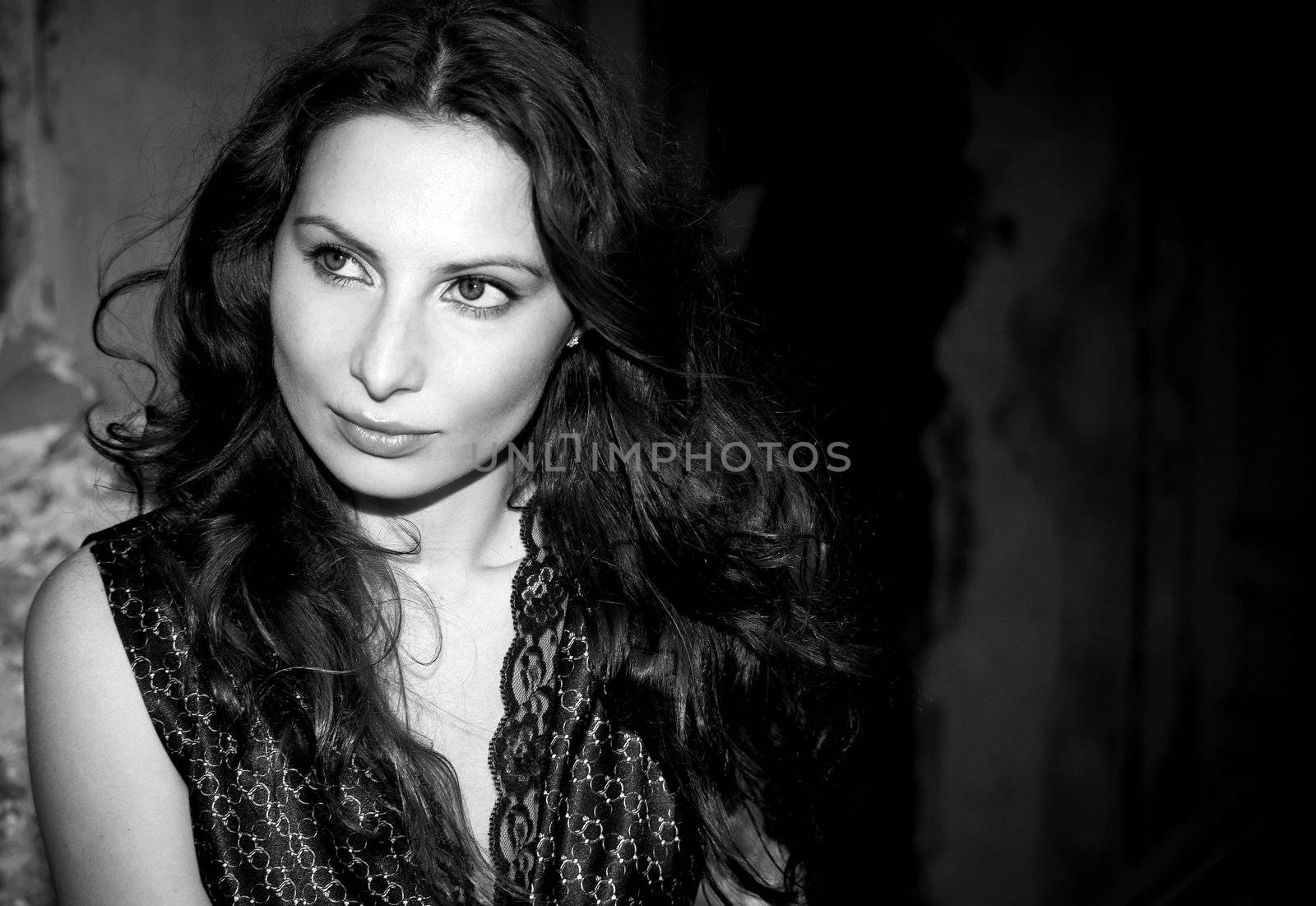 Expressive portrait of young woman on old wall background