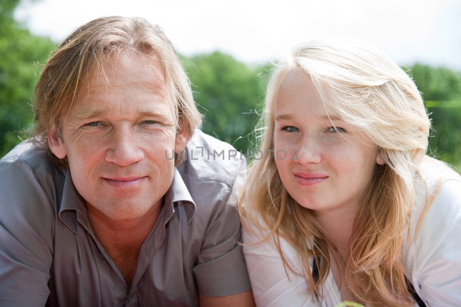 Attractive father and daugter together outdoors in the field