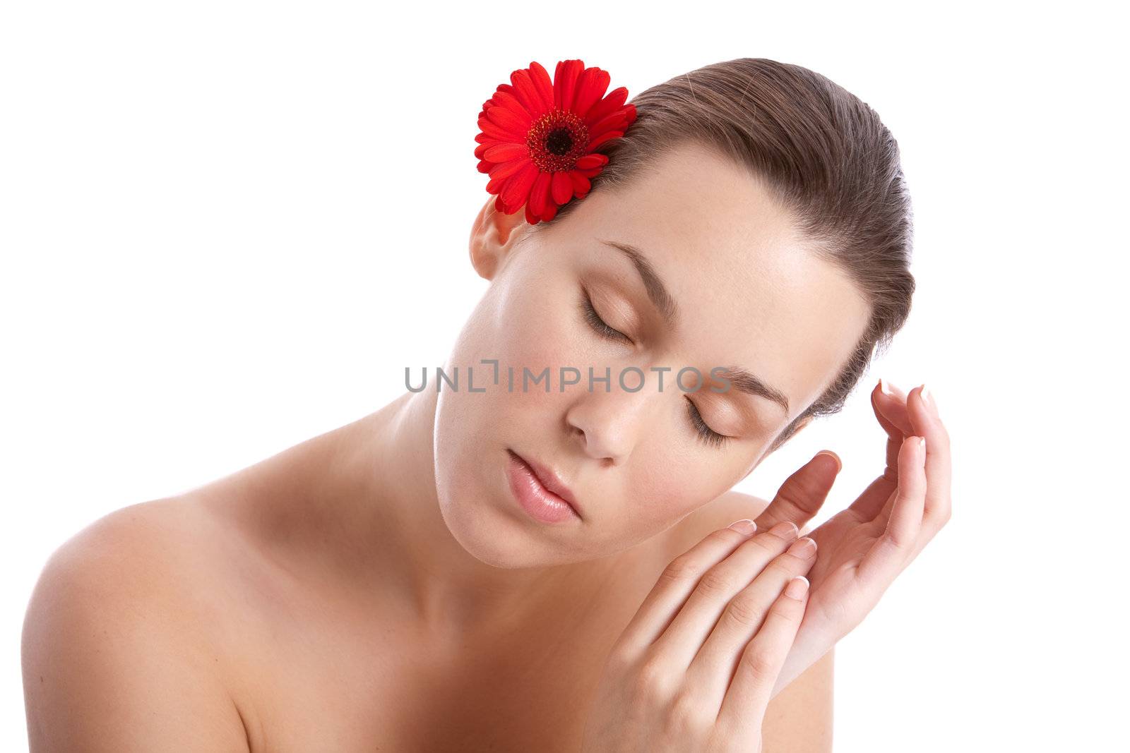 Beautiful woman with red flower behind her ear