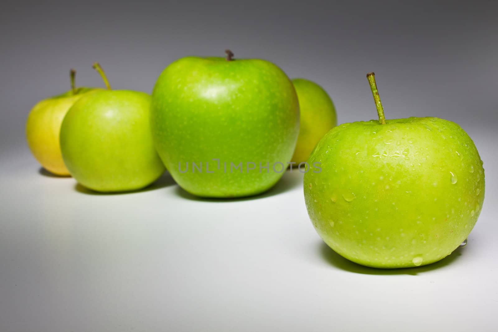 Several fresh green apples isolated on white