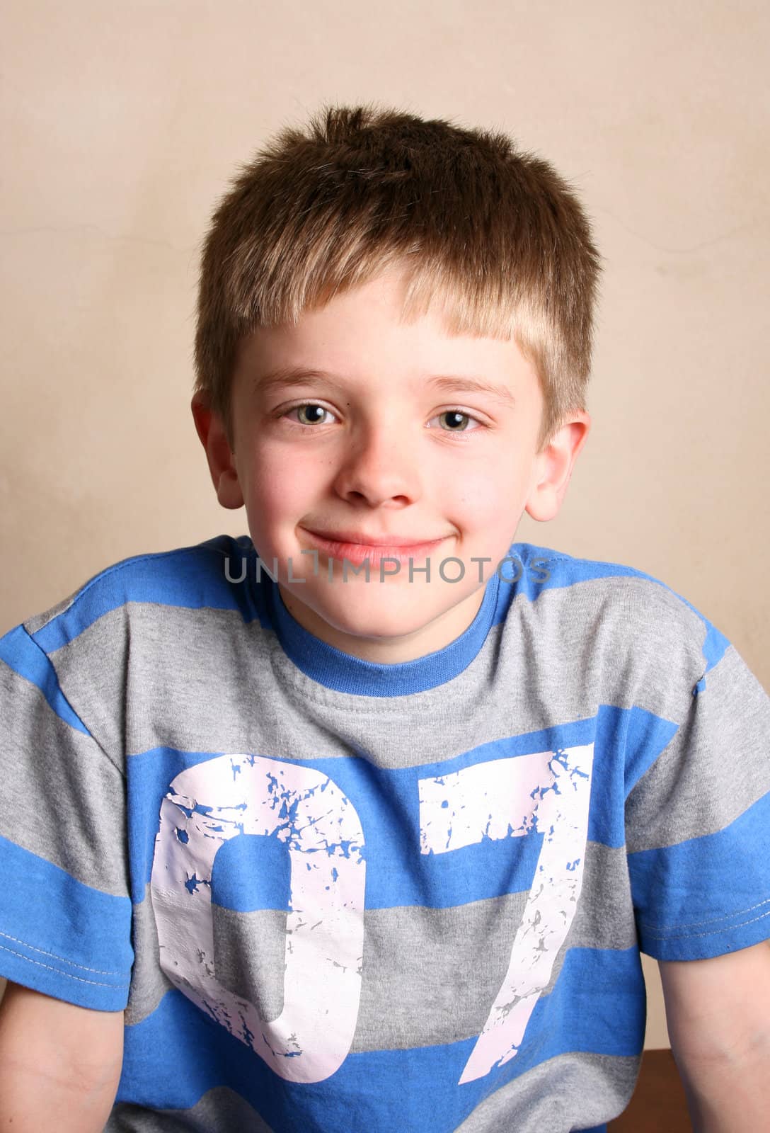 Friendly boy with a blue shirt against a light background
