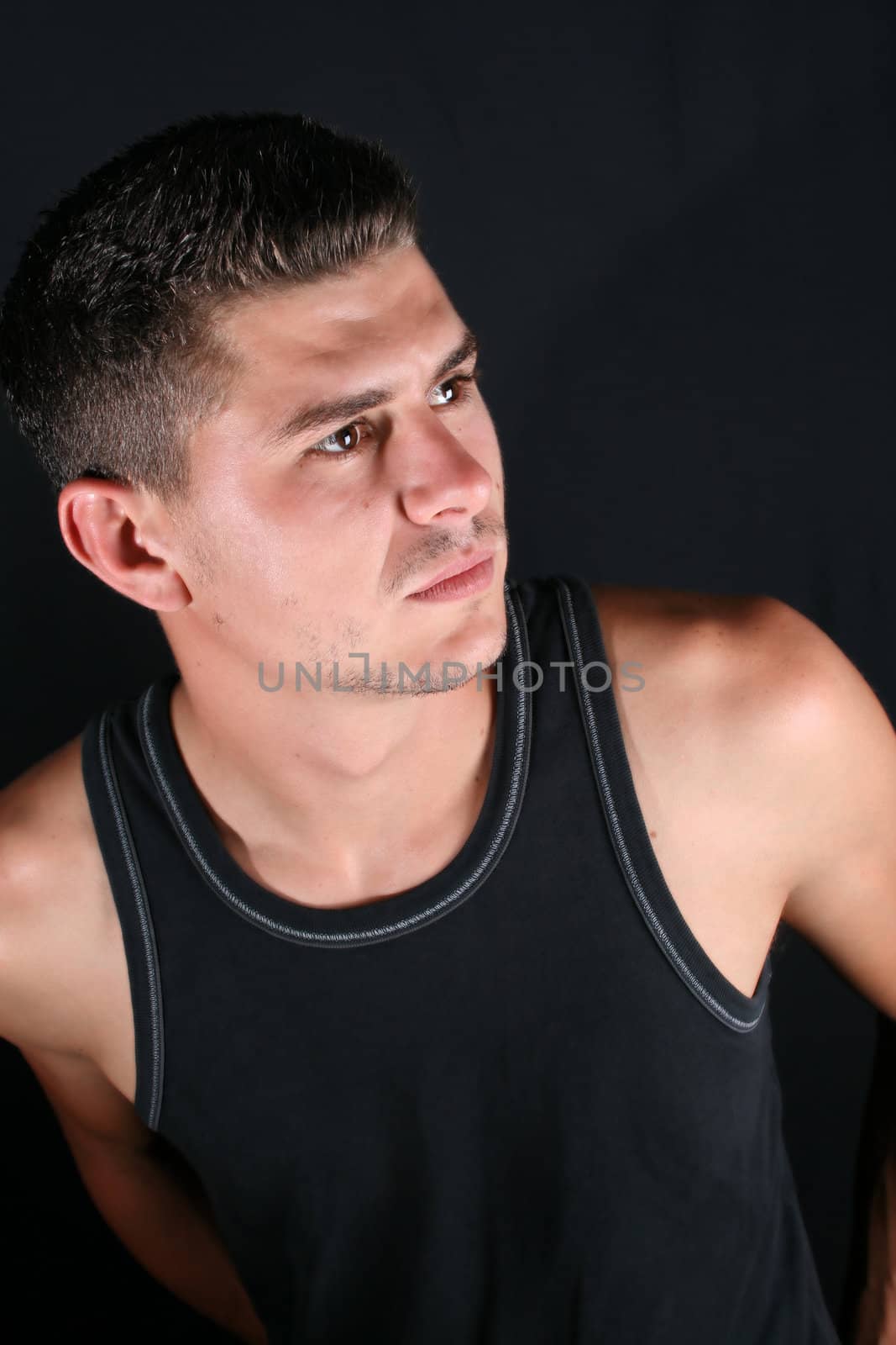 Male model in studio against black background
