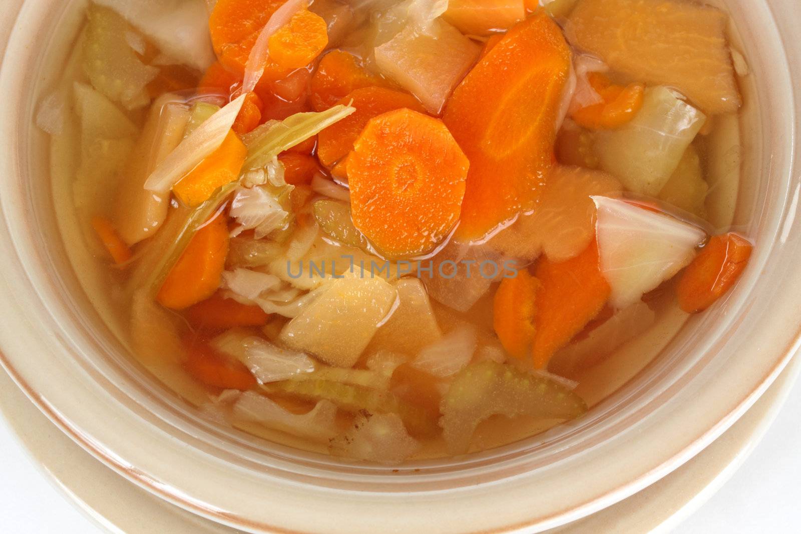 closeup on homemade vegetable soup in a beige bowl