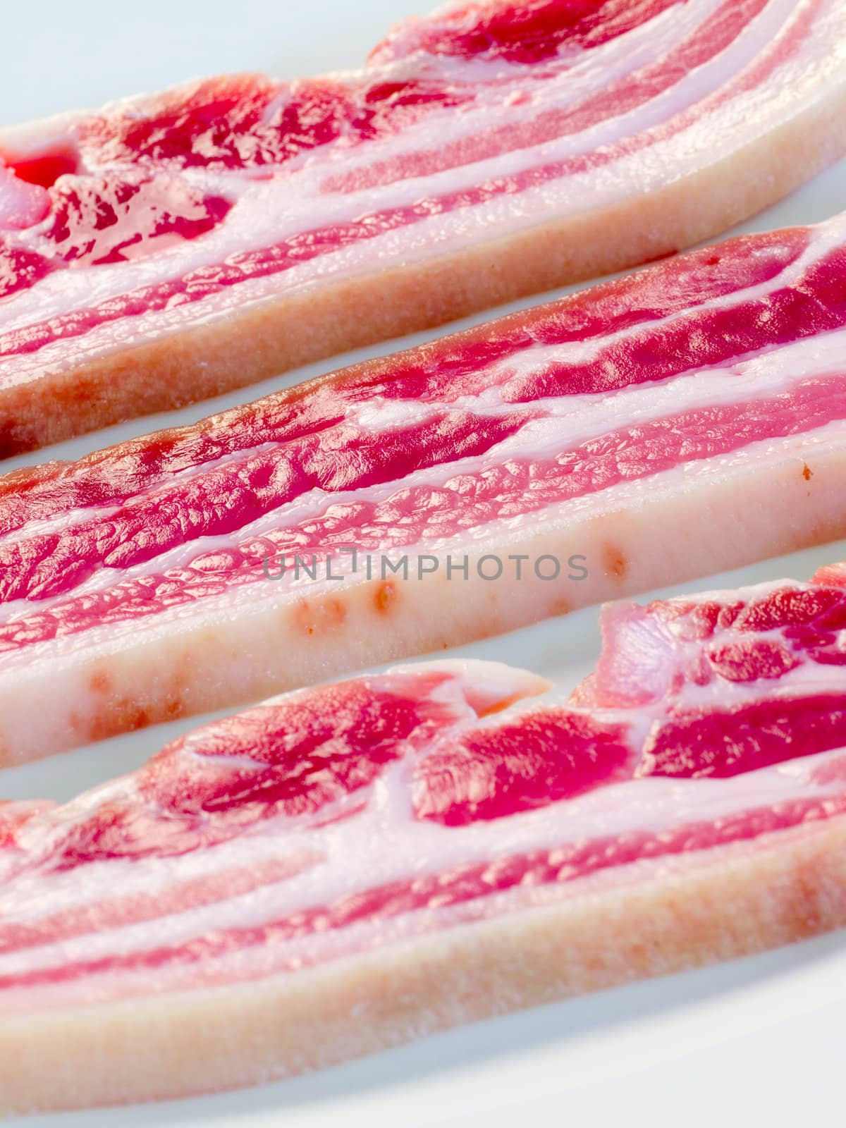 close up of strips of pork belly