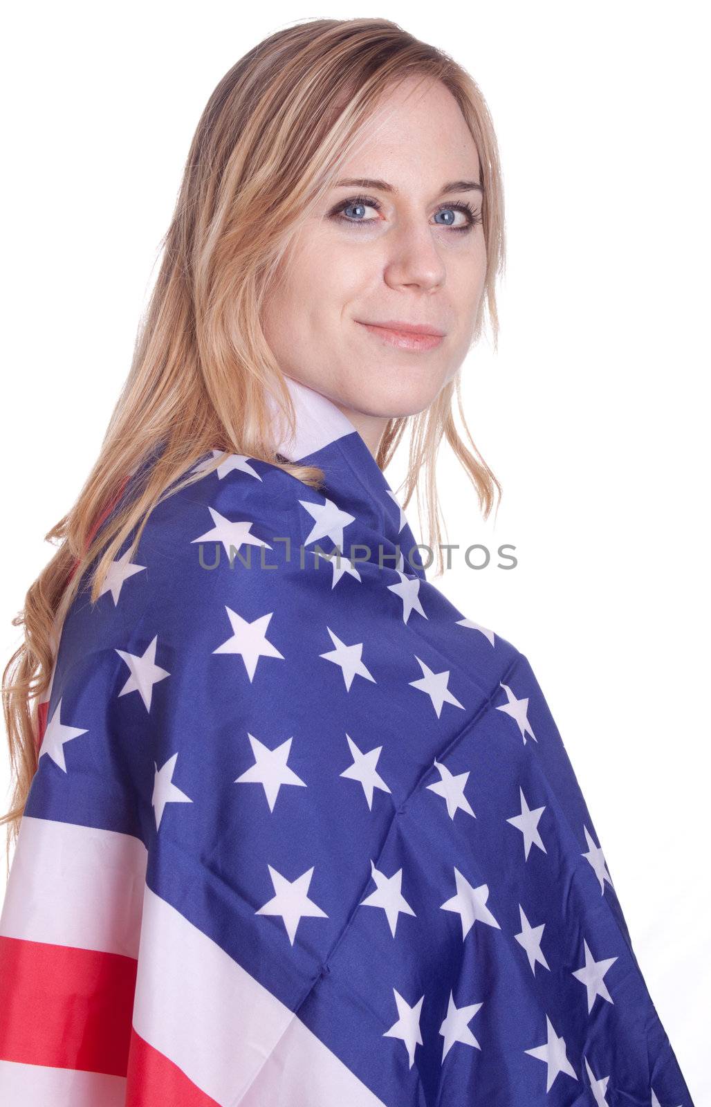 A girl is covered with an American flag.