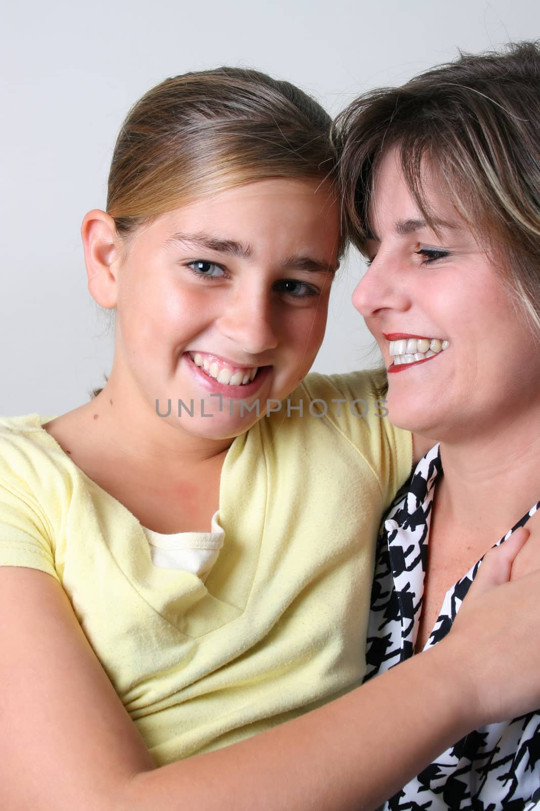 Beautiful mother and daughter on a white background
