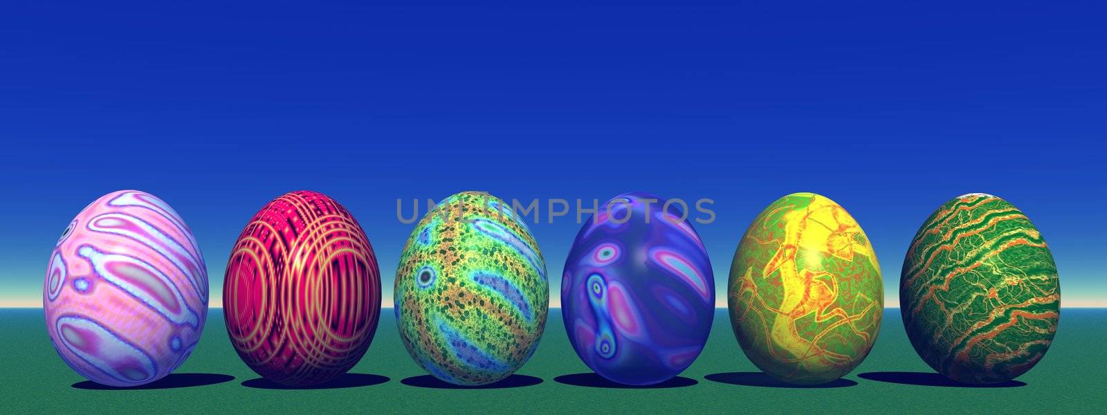 Six colored eggs for easter in the grass and with blue sky