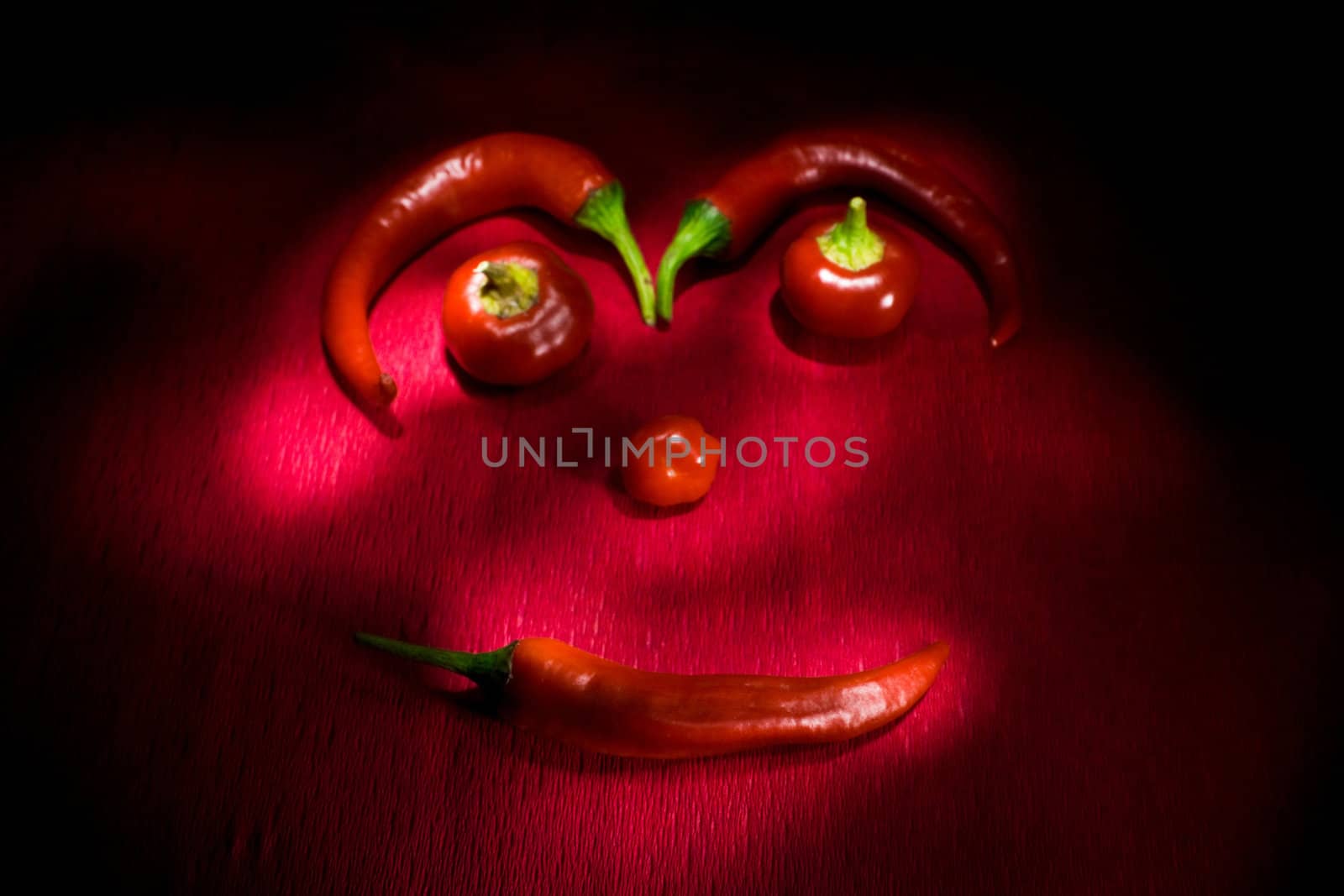 Red chili pepper on red background