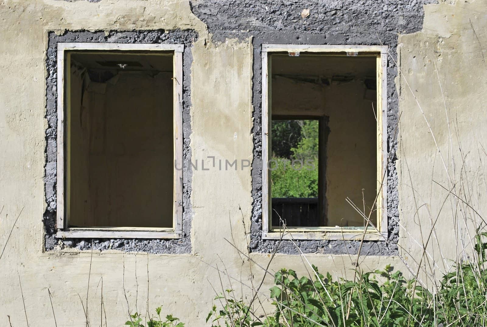 old ruined house, wall and two windows