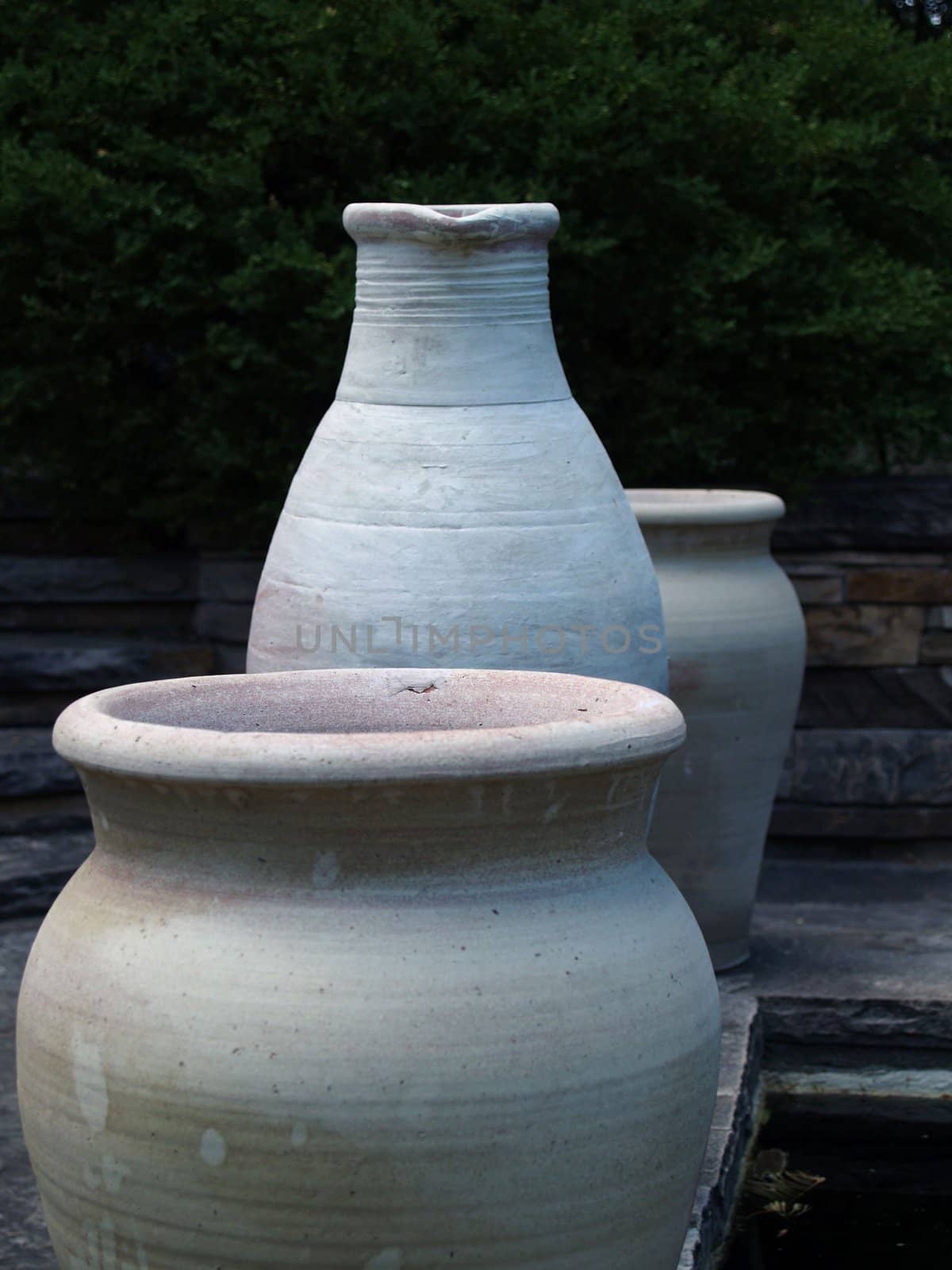 three clay pots sitting in a row